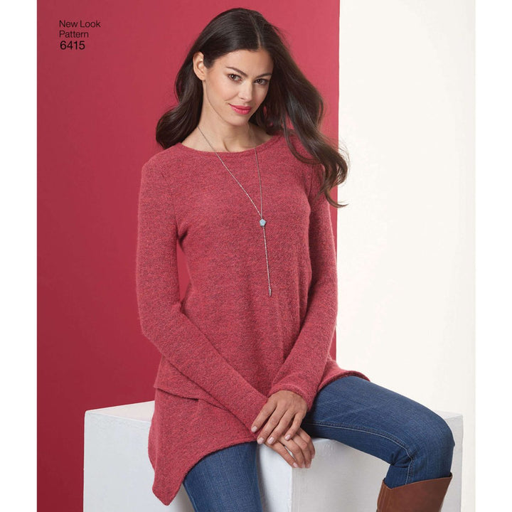 A woman wearing the Pattern - New Look - N6415 - Misses’ Knit Tunic by Super Cheap Fabrics, in a vibrant red color, is seated on a white block against a two-tone red and white background. She complements her eye-catching top with blue jeans and a long silver necklace, with her hands resting gently on her lap.