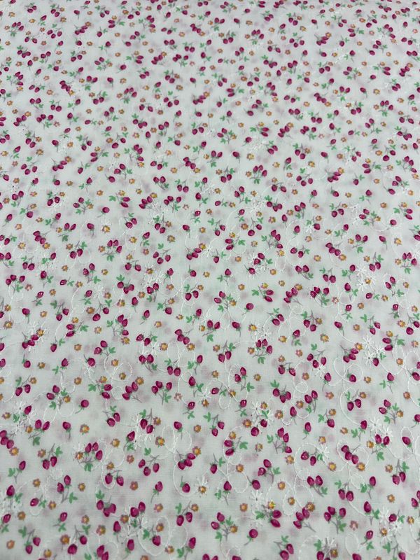 The Embroidered Printed Cotton - Posy by Super Cheap Fabrics is a 112cm lightweight fabric featuring an intricate embroidery of small pink, green, and orange flowers on a light background. Made from natural cotton fibers, it combines elegance with comfort, showcasing a delicate and colorful floral pattern.