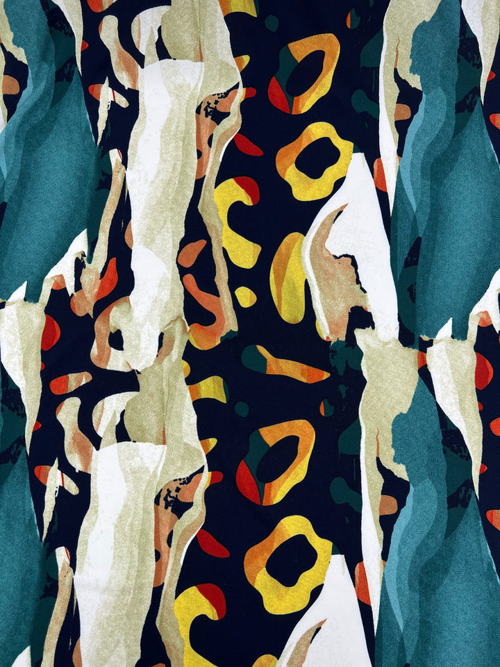 A vibrant abstract pattern featuring irregular shapes and brushstrokes adorns this medium weight fabric. The design includes green, beige, and white vertical elements with scattered yellow, orange, and red spots on a black background, creating a dynamic and colorful composition with a teal backing. This is the Printed Lycra - Melt - 150cm by Super Cheap Fabrics.