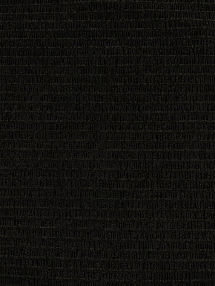 An image of the "Designer Mesh - Black Rouge - 130cm" by Super Cheap Fabrics showcases a textured black surface with a subtle grid pattern. Made from lightweight fabric, the slightly reflective material highlights the uniform grid design when illuminated, likely due to its polyester spandex composition.