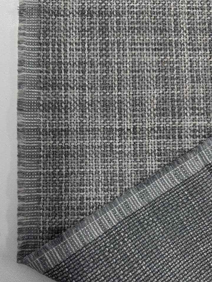 Close-up of Super Cheap Fabrics' Chunky Basket-Weave Upholstery in Marque Dove (145cm), showing a folded corner with its tight, durable backside—ideal texture and look for pairing with coastal-inspired furniture.