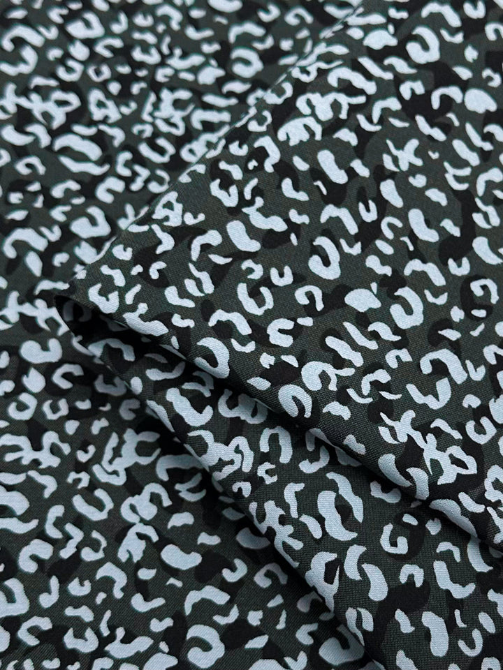 This medium-weight woven fabric, the Printed Bengaline - Luana by Super Cheap Fabrics, showcases a bold black and white abstract leopard print. Width: 150cm.