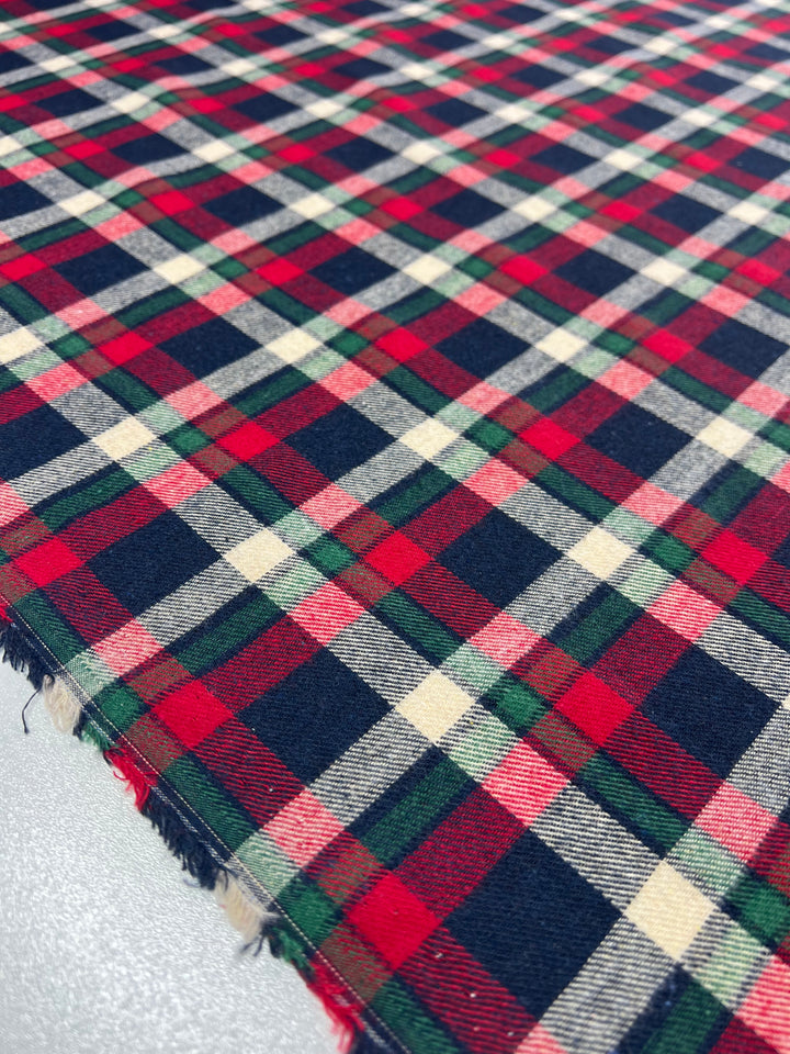 A close-up of Super Cheap Fabrics' Suiting - Cherry Tattersal (150cm) showcases the intricate weave of this versatile, lightweight textile, ideal for crafting elegant twill suiting.