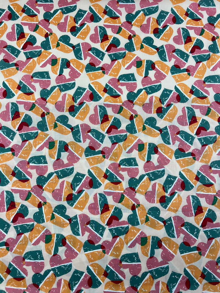 An intricate, colorful pattern printed on natural cotton fibers features overlapping abstract shapes in pink, green, yellow, and orange on a white background. The shapes are a mixture of geometric and organic forms, creating a busy, lively, and visually engaging multi-use fabric design. This is the Printed Cotton - Fruity Candy Hearts - 148cm from Super Cheap Fabrics.