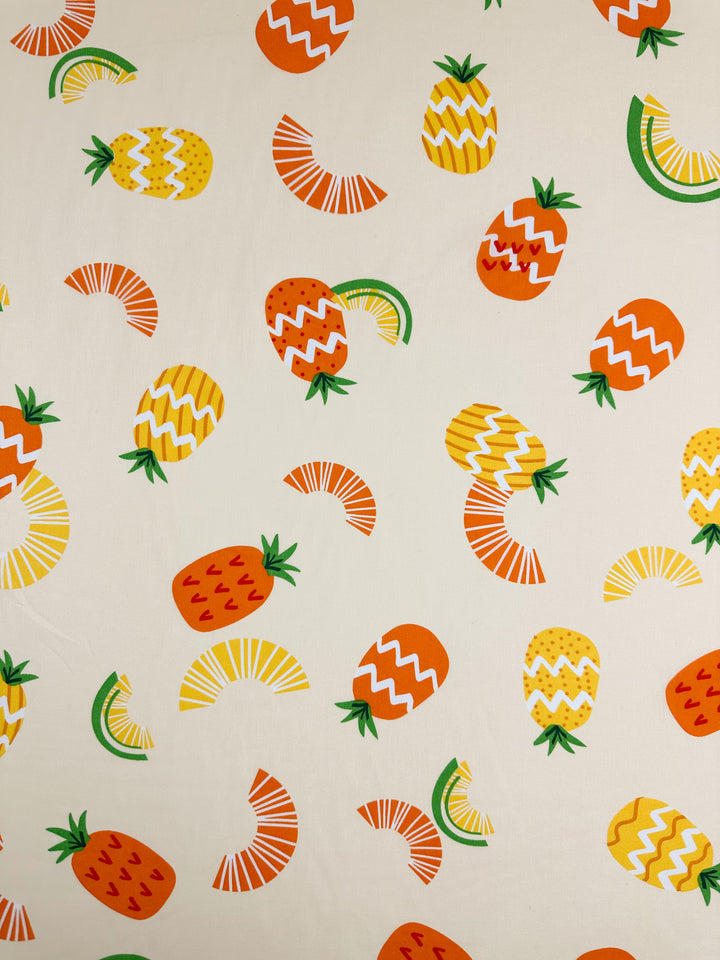 The Printed Cotton - Summer - 150cm by Super Cheap Fabrics features a delightful array of orange and yellow pineapples, orange strawberries, and semi-circular watermelon slices set against a cream background. Each fruit is intricately detailed with white zigzag and striped patterns, making this fabric an excellent choice for those who admire the natural beauty of cotton fibers.