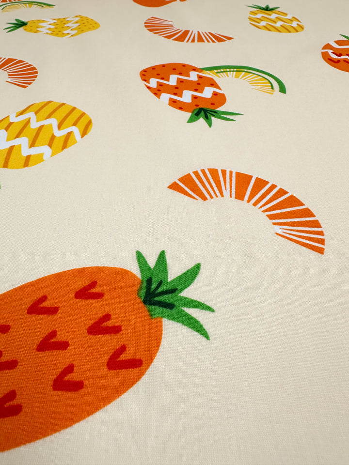 The "Printed Cotton - Summer - 150cm" fabric by Super Cheap Fabrics is a light beige material adorned with playful, stylized fruits in orange and yellow hues. It features strawberries and pineapples accompanied by green leaves and abstract patterns, all crafted from natural cotton fibers. This lightweight fabric is ideal for creating fresh and fun designs.