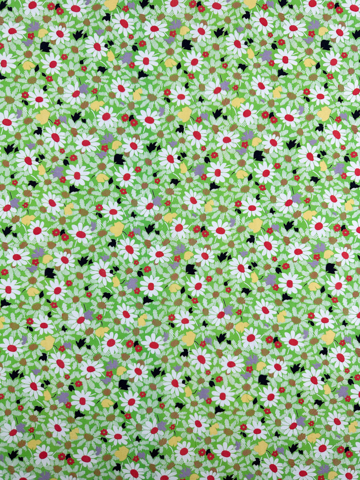 The Printed Linen - Daised - 138cm from Super Cheap Fabrics showcases a lush green base adorned with vibrant white and red floral patterns, accented by small yellow touches. Perfect for garments, its dense design offers a lively, colorful texture.