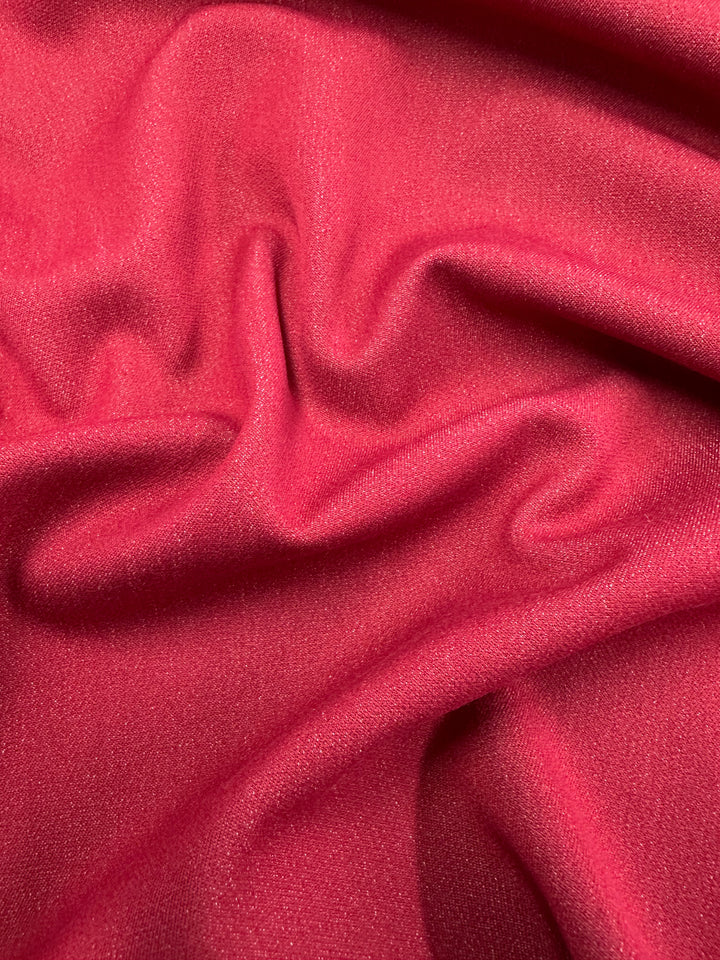 Close-up of smooth, vibrant red Stretch Denim - Scooter - 145cm by Super Cheap Fabrics, with gentle folds and a soft sheen, reminiscent of high-quality denim and creating a rich, luxurious texture.