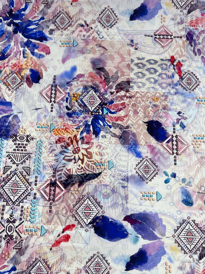 The Printed Cotton - Digital - 150cm by Super Cheap Fabrics showcases an abstract design of geometric and floral patterns on lightweight cotton, blending purples, blues, and earthy tones for a dynamic artistic look.