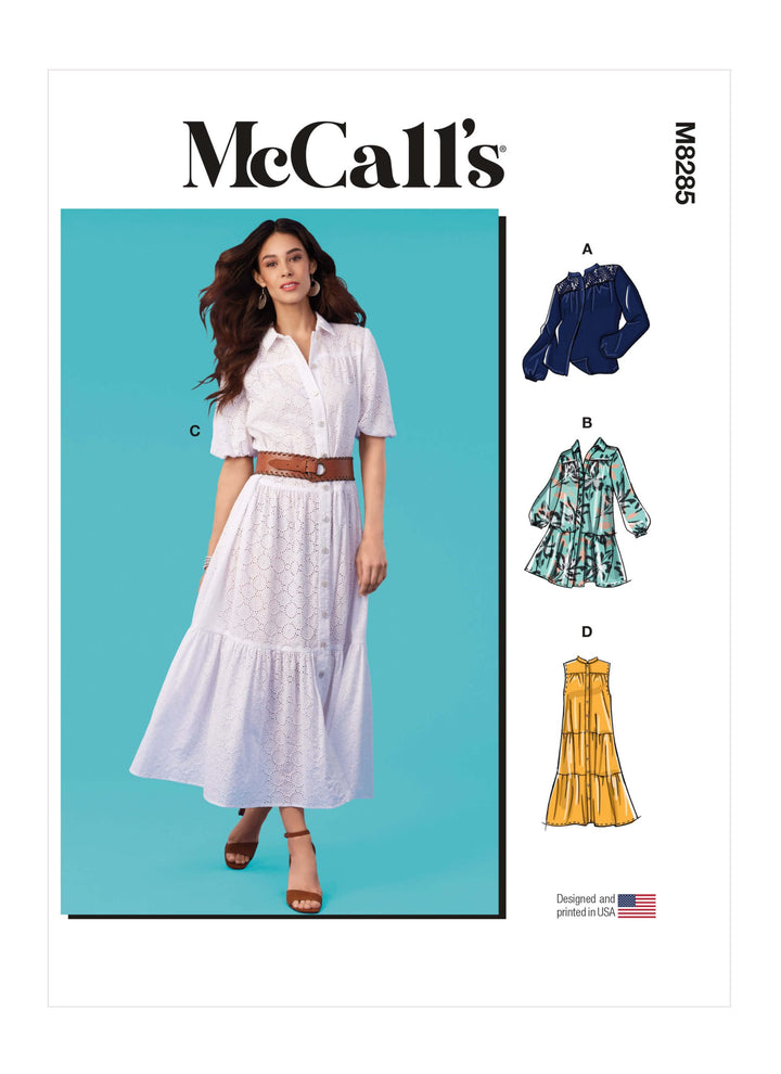 Cover design for McCall's M8285 Pattern by Super Cheap Fabrics. Showcases a model in a white shirtdress with a brown belt set against a blue background. Features illustrations for options A, B, and D: stylish blouse, tunic, and dress in various styles, accompanied by the USA flag.