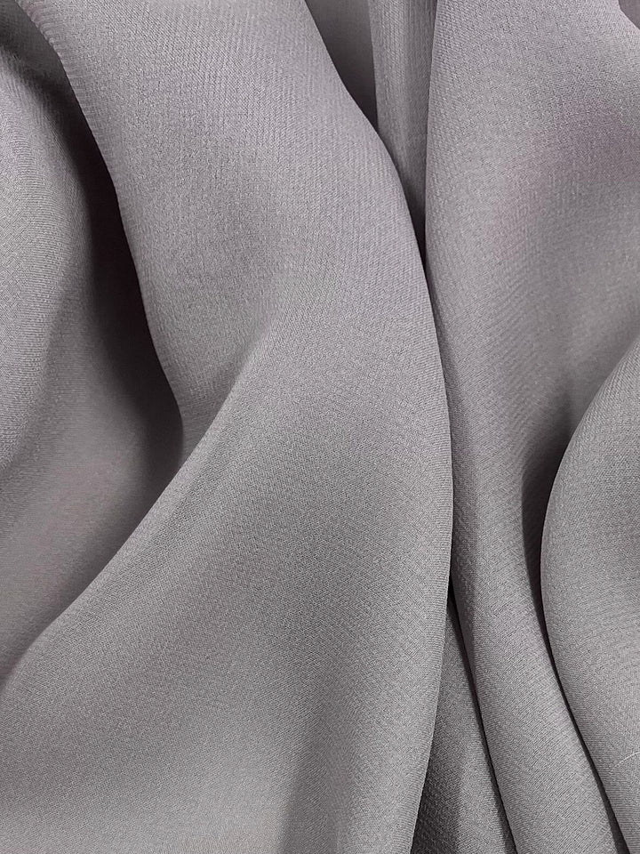 A close-up of Super Cheap Fabrics' Pure Silk Georgette - New Marble (135cm) showcases its soft, flowing material and delicate textures, exuding a serene elegance.