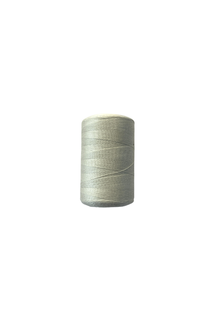 A spool of Thread - Light Grey by Super Cheap Fabrics, 100% spun polyester sewing thread, size 40/2, sits against a plain white background. The thread is neatly wound around the spool, showcasing a smooth and even texture.