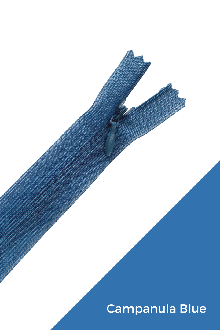 A close-up image showcases a blue zipper partially unzipped, highlighting its invisible zipper design. The words "Campanula Blue" appear in white on a blue diagonal banner in the bottom right corner, emphasizing its elegant finish. The product is the "Invisible Zip - 30cm - Blues" by Super Cheap Fabrics.