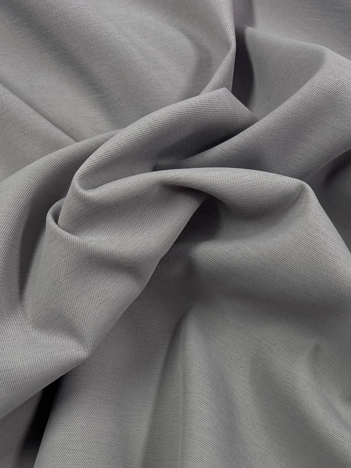 A close-up image of Delustered Satin - Raindrops - 150cm by Super Cheap Fabrics featuring a wrinkled texture. The light-medium weight material appears soft and smooth with gentle folds and creases throughout the surface.