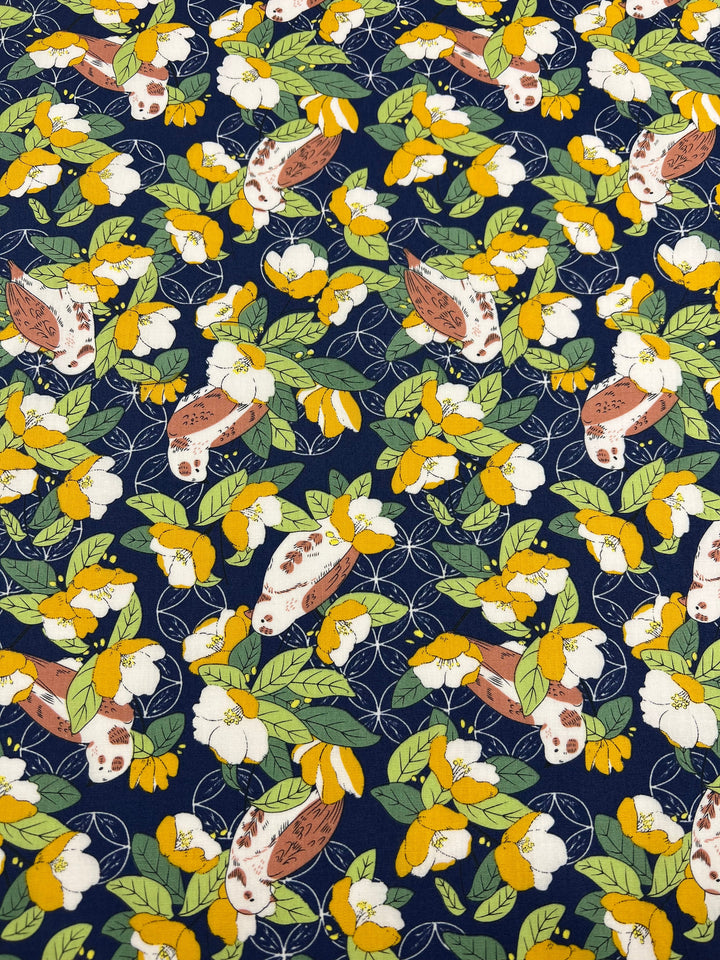 A colorful cotton fabric pattern featuring green leaves, brown and white birds, and clusters of yellow and white flowers on a dark blue background. This dense, evenly distributed botanical print is perfect for multiple uses. Introducing the Printed Cotton - Wild Camellias - 150cm from Super Cheap Fabrics.